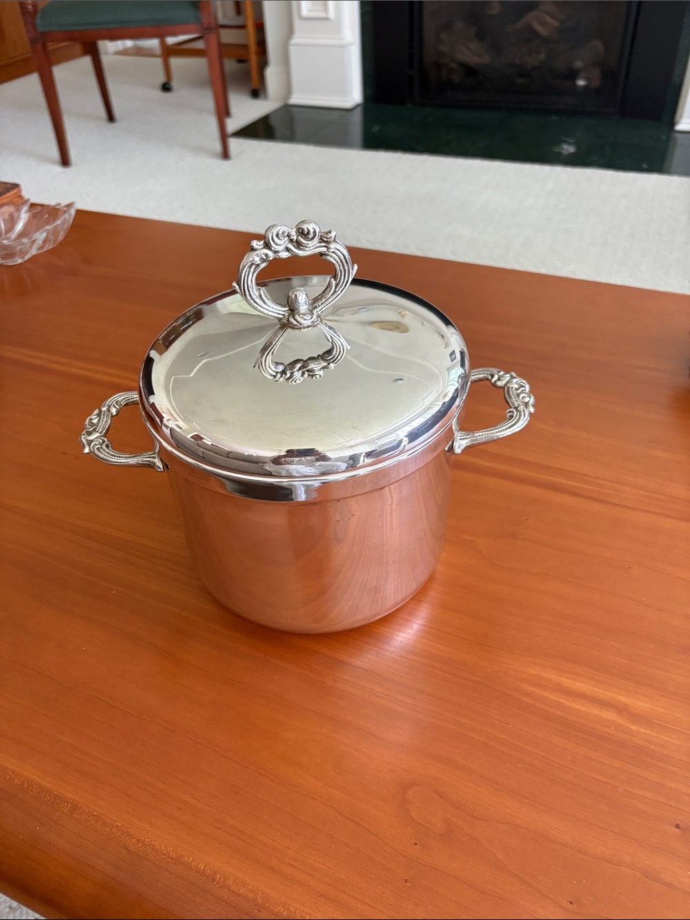 Vintage silver plated ice bucket with decorative handles and lid, and tongs.